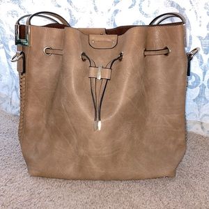 Brown leather bag with gold hardware and lace up sides.